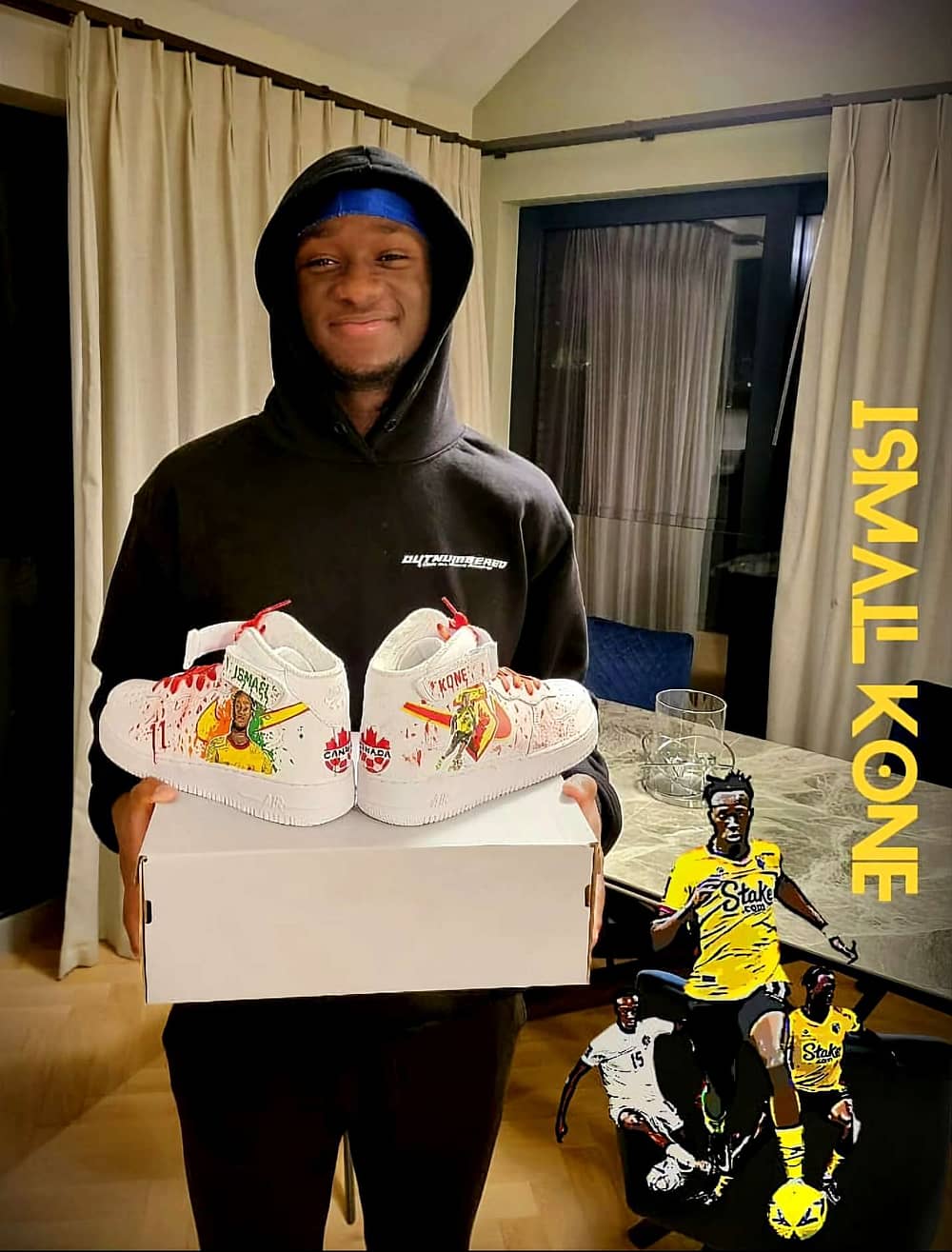 Footballer Ismael Kone holding his hand painted Watford FC custom sneakers