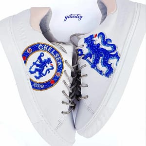 Chelsea FC CFC logo hand painted on white Radley London sneakers, topped with crystals and rhinestones and rhinestone shoelaces - both shoes on white background