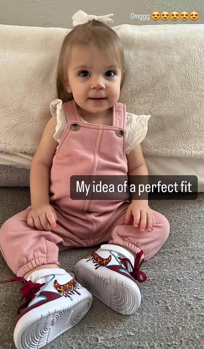 Cute little toddler girl wearing a pair of kids personalised West Ham United FC Nike sneakers in pink outfit