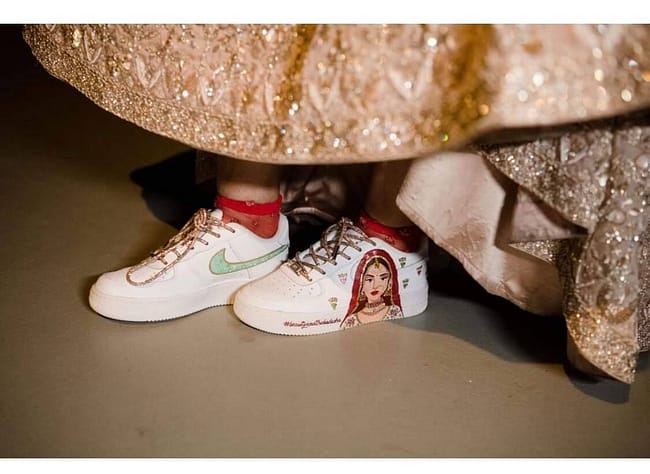 Indian bride in lehenga wearing hand painted bridal Nike AF1 sneakers with crystal laces