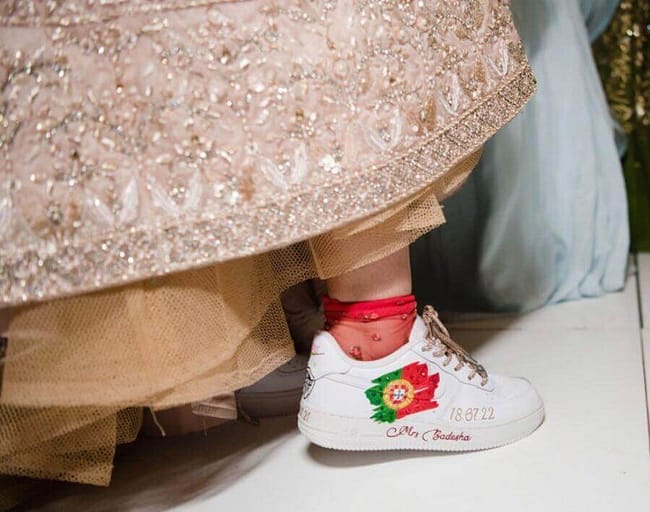 Bride in lehenga wearing hand painted custom bridal Nike AF1 sneakers - Portugal flag