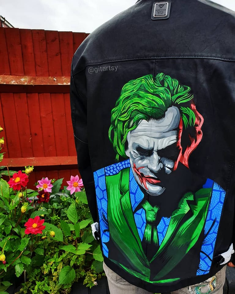 Hand painted leather jacket with a portrait of Joker from Batman movie. Painted in neon colours